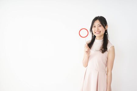 Young woman showing the circle signの写真素材
