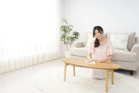 Young woman cleaning her houseの写真素材