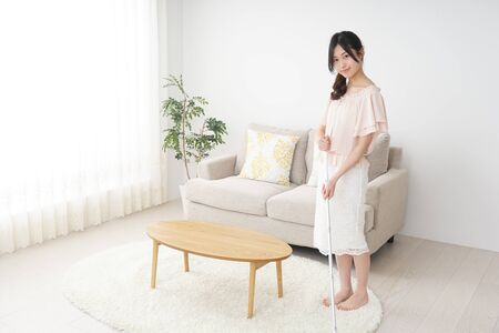 Young woman cleaning her houseの写真素材