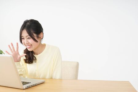 Young woman making a video phone callの写真素材