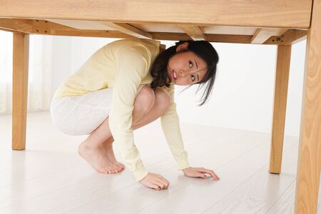Young woman saving from an earthquakeの写真素材