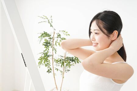 Young woman trussing the hairの写真素材