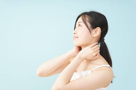 Young woman taking a body careの写真素材