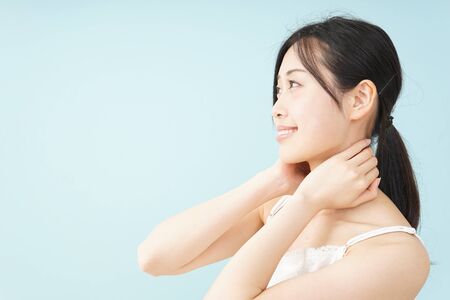 Young woman taking a body careの写真素材