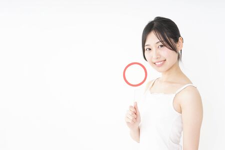 Young woman showing the circle signの写真素材