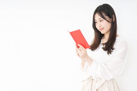 Young woman taking a noteの写真素材