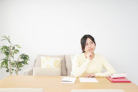 Young woman studying at homeの写真素材