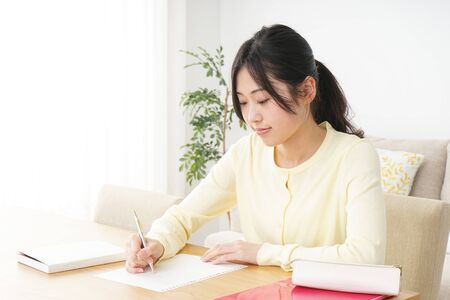 Young woman studying at homeの写真素材