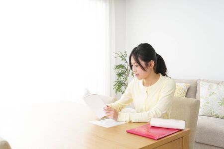 Young woman studying at homeの写真素材