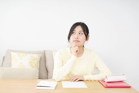 Young woman studying at homeの写真素材