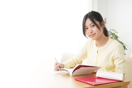 Young woman studying at homeの写真素材