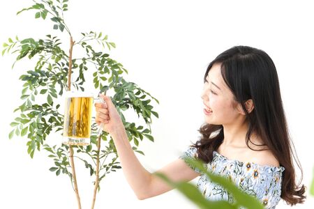 Young woman drinking beer outsideの写真素材