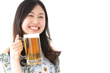 Young woman drinking beer outsideの写真素材
