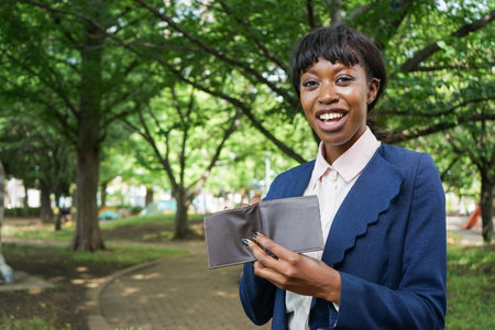 african woman looking at her wallet