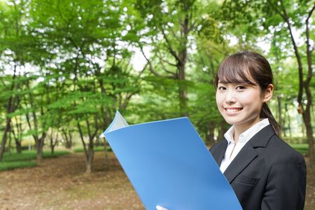 Young business woman holding documentsの写真素材