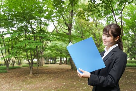 Young business woman holding documentsの写真素材