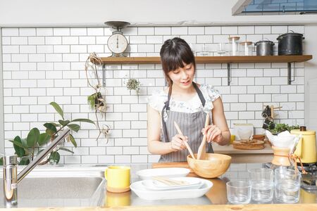young woman cookingの写真素材