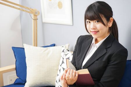 woman in suit reading a bookの写真素材