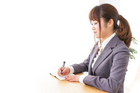 Business woman taking notesの写真素材