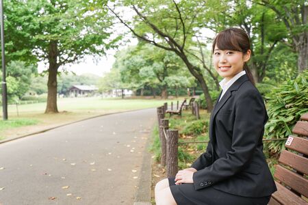 Business woman sitting on the benchの写真素材