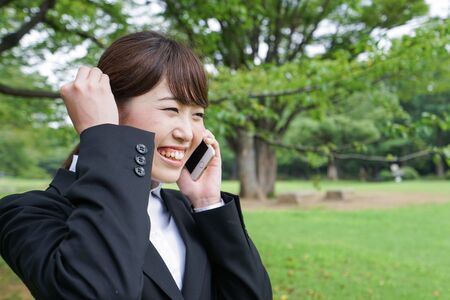 Business woman calling outsideの写真素材