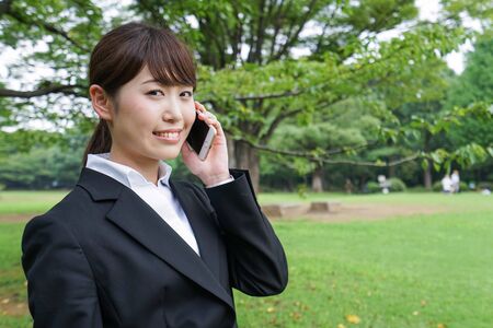 Business woman calling outsideの写真素材