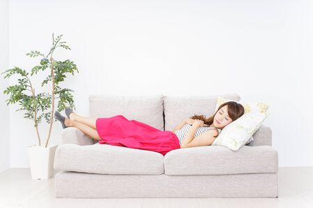 Young woman sleeping on the sofaの写真素材