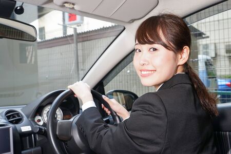 Young business woman in carの写真素材