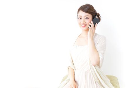 woman in dress using a smartphoneの写真素材