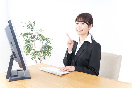 business woman pointing to something in officeの写真素材