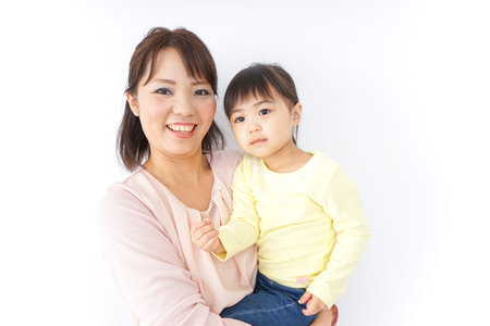 Mother carrying the child in her armsの写真素材