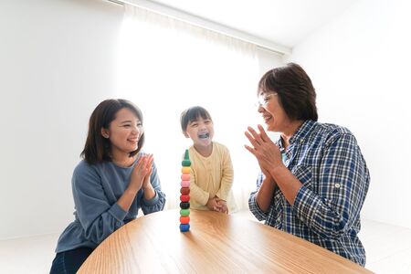 Happy family playing with childの写真素材