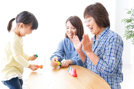 Happy family playing with childの写真素材