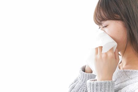 Woman blowing her noseの写真素材