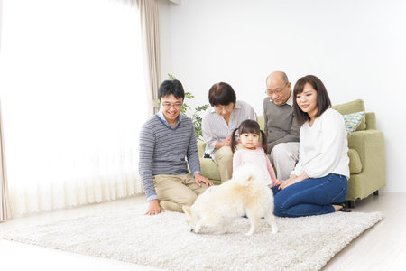 Three-generation family taking care of dog
