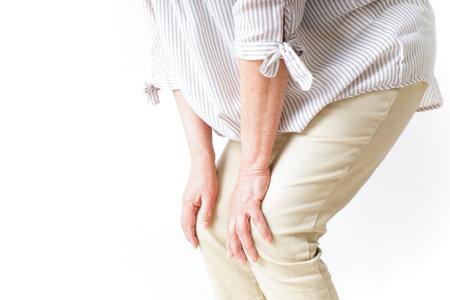Aged woman suffering from pain in knee