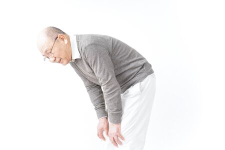 Aged man suffering from pain in kneeの写真素材