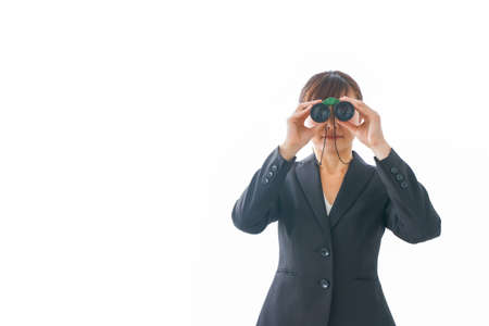 Business woman looking through binoculars on white background, business vision conceptの写真素材