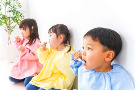 Children brushing teeth in the living room at home. Health care conceptの写真素材