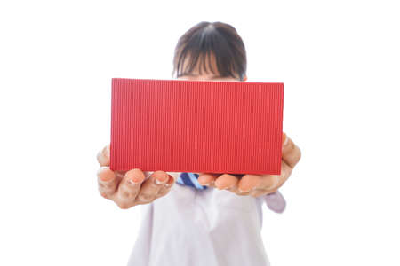 Young female doctor holding a red gift box isolated on white background.の写真素材