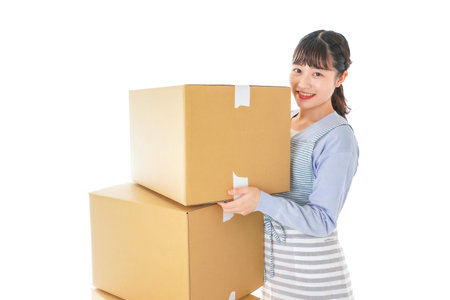 A young asian woman holding a stack of boxes high quality photo