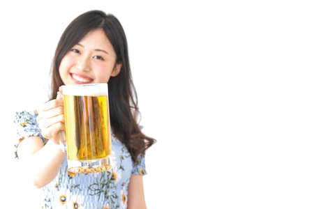 Young woman drinking beer outsideの写真素材