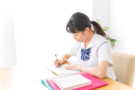 Student studying at home image taken in the studio with soft light.の写真素材