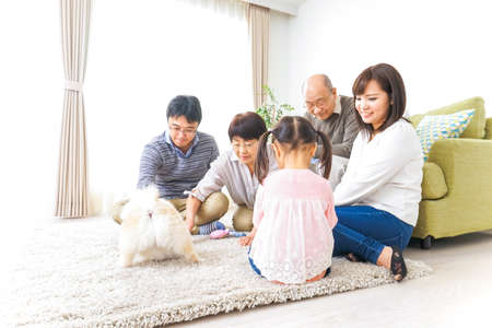 Family playing with dogの写真素材