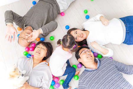 Family playing with dogの写真素材