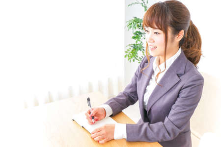 Business woman taking notesの写真素材