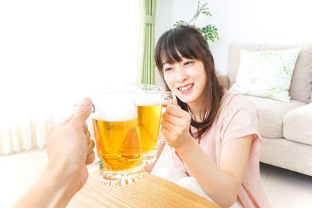 Young woman drinking beerの写真素材