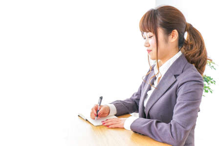 Business woman taking notesの写真素材