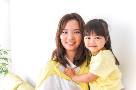 Mother holding a child on her hipの写真素材