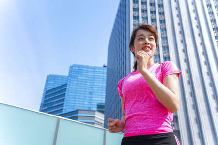 Woman running in cityの写真素材